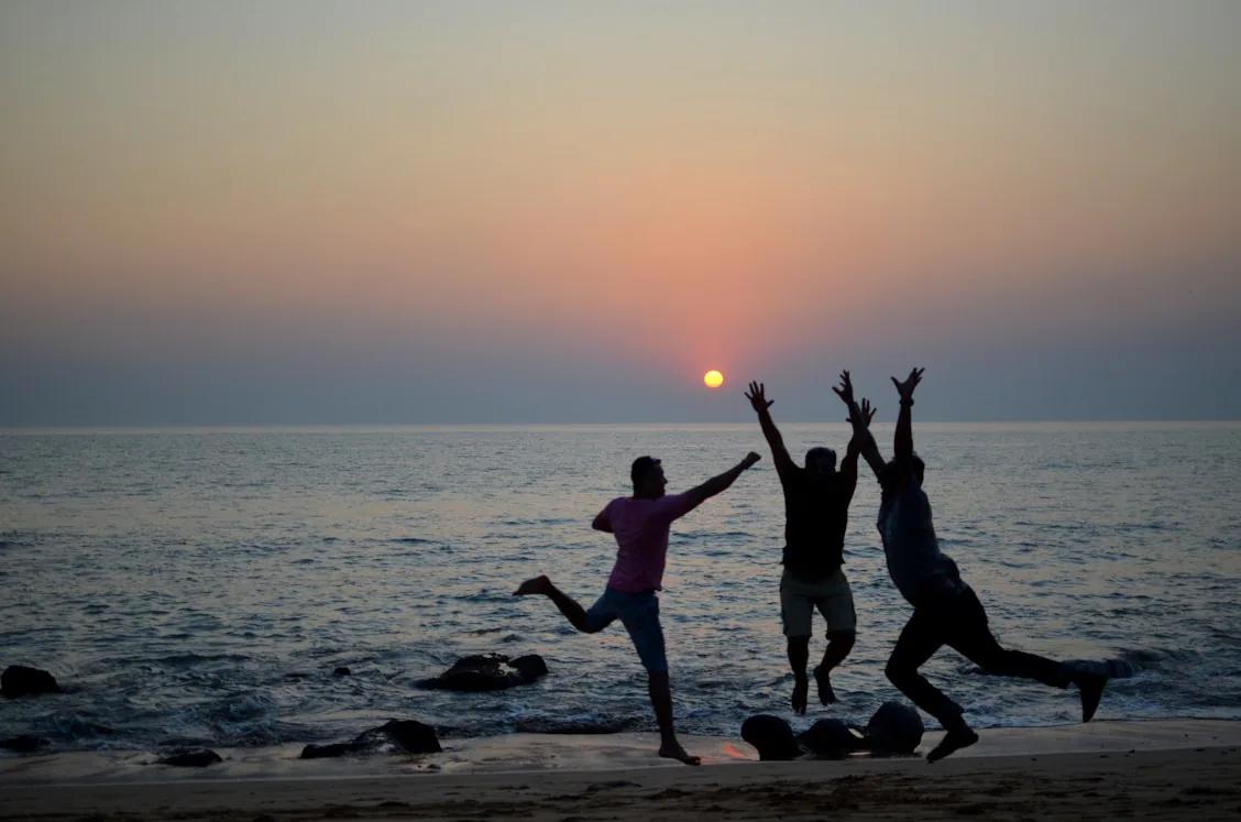 People expressing joy together by the sea